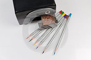 Top view of electric pencil sharpener and colored pencils