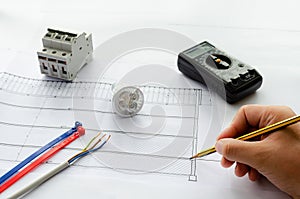 Top view of electrical tools and materials for electrical system, cable and cable ties, breakers, led bulb and Multi-meter