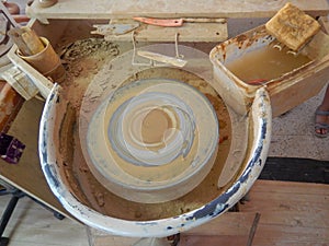 Top view of a electrically rotating potter& x27;s wheel, stacked mud on it to make potter products