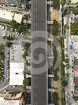 Top view of an elevated highway and a parking lot. Aerial of the Metro Manila Skyway in the Philippines photo