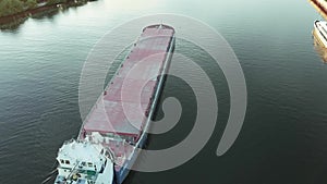 Top view of empty barge without cargo float along the river in summer sunny day