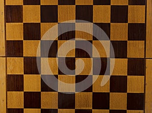 Top view of empty chess board made of wood.Texture of chess board