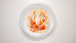 TOP VIEW: Empty and dirty dish after a spaghetti with tomato sauce