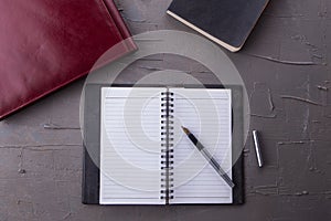 Top view of empty notebook with office equipments on desk.