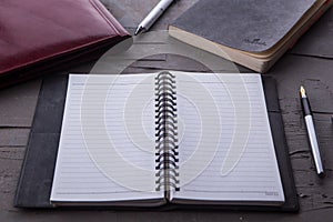 Top view of Empty notebook with office equipments on desk.