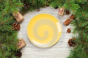 Top view. Empty plate round ceramic on wooden christmas background. holiday dinner dish concept with new year decor