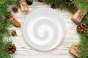 Top view. Empty plate round ceramic on wooden christmas background. holiday dinner dish concept with new year decor