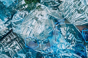 Top view of empty rumpled used blue plastic bottles background