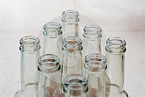 Top view of empty soft drinks glass bottles on the floor. Close up.