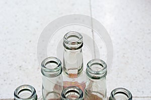 Top view of empty soft drinks glass bottles on the floor. Close up.