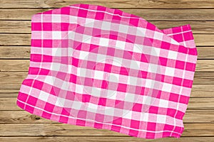 Top view of a empty violet and white checkered kitchen cloth, textile, tablecloth or napkin on blurred wooden background. Template