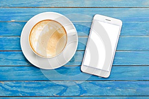 Top view empty white coffee cup (latte coffee) and smartphone wi