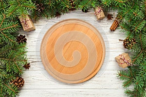 Top view. Empty wood round plate on wooden christmas background. holiday dinner dish concept with new year decor