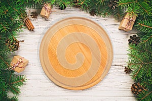 Top view. Empty wood round plate on wooden christmas background. holiday dinner dish concept with new year decor