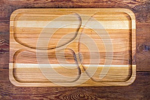 Top view of empty wooden compartment dish with three departments