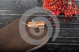 Top view of empty wooden cutting board on dark tabletop