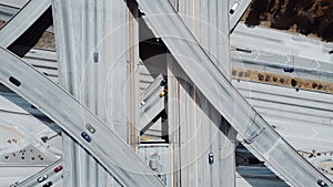 Top view epic drone lockdown shot of Judge Pregerson highway interchange with cars on multiple level road junctions.