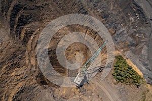 Top view excavator removes overburden from soil to extract open pit mine coal, Aerial drone