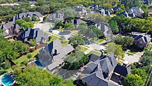 Top view expensive two story mansion houses with swimming pools near a cul-de-sac in Grapevine, Texas, USA