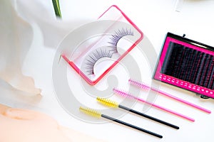 Top view Eyelash extension tools on white background, brush lash