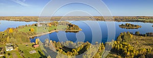 Top view of fall forest and lake. Autumn sunny evening over a forest lake.