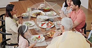 Top view, family and dinner or happy with food at dining table for bonding, event or conversation in living room of home