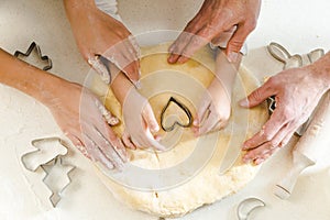 top view of family hands on dough