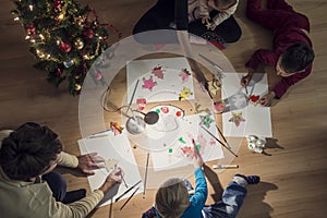 Top view of a family with two kids and a baby making Christmas d
