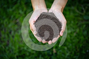Top view. Farmer holding soil in hands.  The researchers check the quality of the soil.  Agriculture, gardening or ecology concept