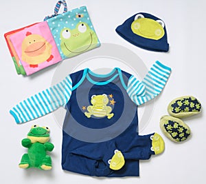 Top view fashion trendy look of baby boy clothes and funny frog