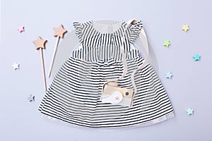 Top view fashion trendy look of baby girl clothes and toy stuff. Baby fashion concept