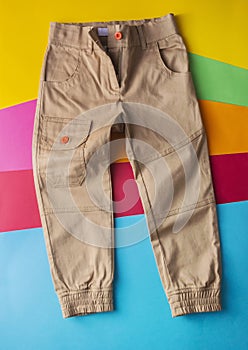 Top view fashion trendy look of boys clothes and shoes, fashion concept, outfit, colors background, Stylish child look.