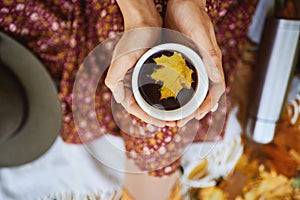 Top view of fashionable autumn style girl holding cup with coffee