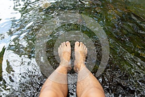 Top view of Feet soaking in the stream