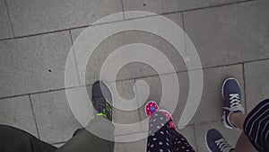 Top view of the feet walking up the stairs.