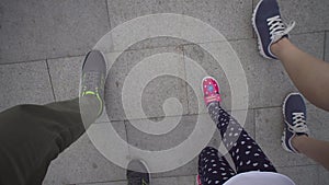 Top view of the feet walking up the stairs.