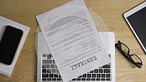 Top view of female hands checking and signing by pen a contract, then squeeze paper. Businesswoman working at table in