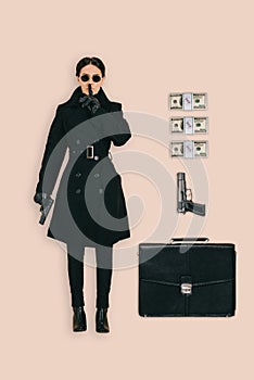 top view of female killer in sunglasses doing shushing gesture with briefcase handguns and cash