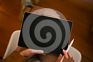 Top view, Female using her digital tablet touchpad to entertain herself