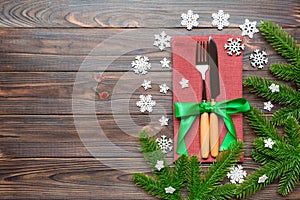 Top view of festive cutlery on new year wooden background. Christmas decorations with empty space for your design. Holiday dinner