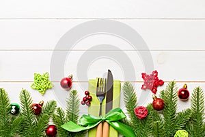 Top view of festive cutlery on new year wooden background. Christmas decorations with empty space for your design. Holiday dinner