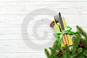 Top view of festive cutlery on new year wooden background. Christmas decorations with empty space for your design. Holiday dinner