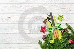 Top view of festive cutlery on new year wooden background. Christmas decorations with empty space for your design. Holiday dinner