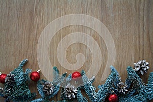 Top view fir branch with Christmas decorations on wooden shabby background with copy space for text, soft focus