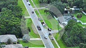 Top view of first responders at accident site on american street. Emergency services personnel helping victims of car