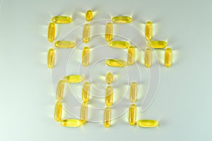Top view of Fish oil capsules on white background. Omega 3. Vitamin E. Supplement food for good life