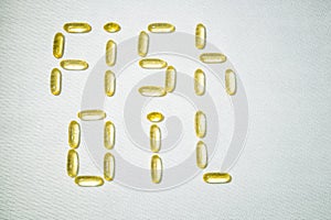 Top view of Fish oil capsules on white background. Omega 3. Vitamin E. Supplement food for good life