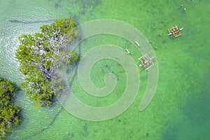 Top view of Fishing boats anchored at shallow waters at a mangrove area in Calape, Bohol