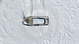 Top view of fishing boats on a snowy beach, winter