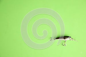 Top view of fishing lure isolated on green background